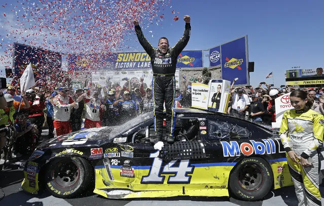 Tony Stewart, center, celebrates after winning the NASCAR Sprint Cup Series auto race Sunday, June 26, 2016, in Sonoma, Calif. (Photo by Ben Margot/AP Photo)