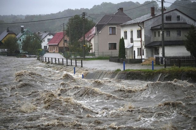 The Bela River flows past homes during floods in Mikulovice, Czech Republic, Saturday, September 14, 2024. (Photo by Petr David Josek/AP Photo)