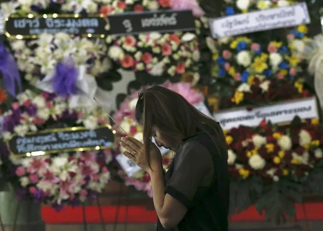 A relative of Thai victim from Monday's bomb blast, Waraporn Changtam, prays during a Buddhist funeral at a temple in Nonthaburi province, on the outskirts of Bangkok, Thailand, August 19, 2015. (Photo by Chaiwat Subprasom/Reuters)