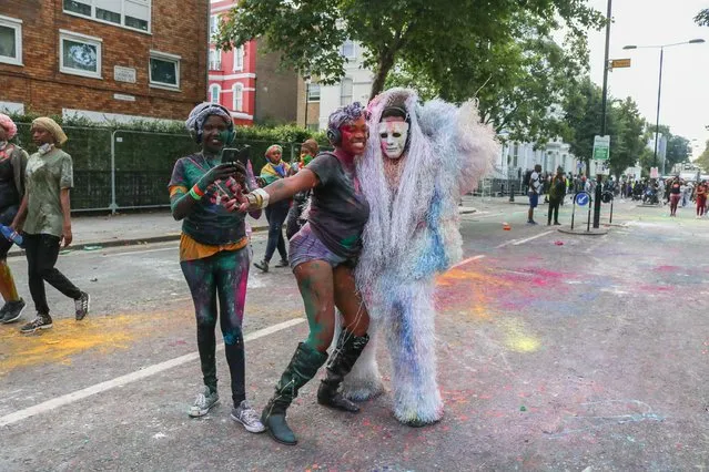 Participants throw flour and cover each other in jouvay chocolate and coloured paint in the traditional Caribbean tradition known as Jouvert to kick off the Notting Hill carnival celebrations  in London, England on August 27, 2017 – which is expected to receive 1 million visitors over the August bank holiday weekend. (Photo by Amer Ghazzal/Rex Features/Shutterstock)
