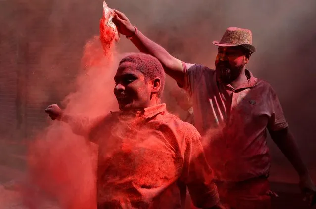 A man dances as another throws coloured powder at him during Holi celebrations in Kolkata, India, March 10, 2020. (Photo by Rupak De Chowdhuri/Reuters)