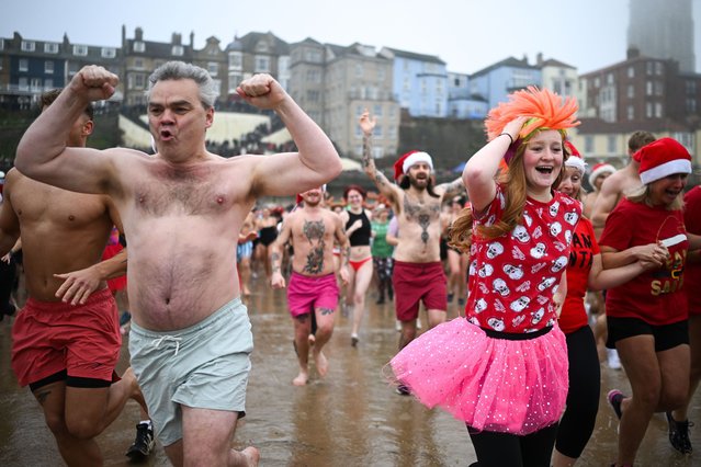 People run into the sea at the start of the Cromer Boxing Day dip in Cromer, UK on December 26, 2024. (Photo by Victoria Jones/Rex Features/Shutterstock)