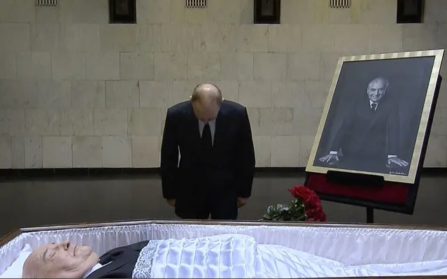 In this image taken from video provided by the Russian pool television on Thursday, September 1, 2022, Russian President Vladimir Putin pays his last respect near the coffin of former Soviet President Mikhail Gorbachev at the Central Clinical Hospital in Moscow Russia. (Photo by Russian pool via AP Photo)