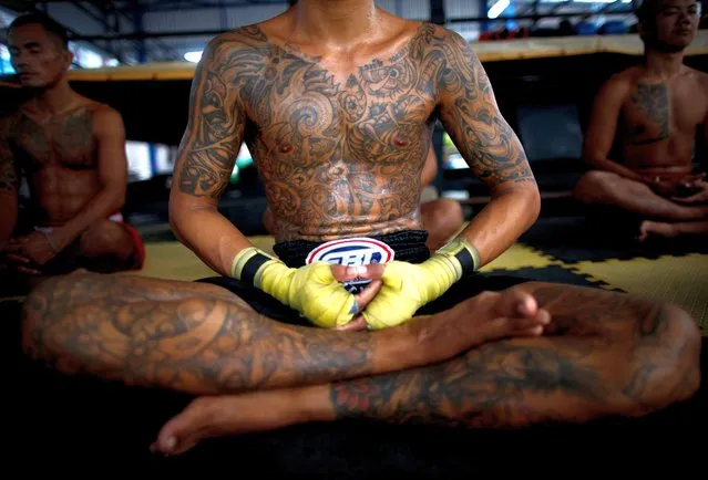 Thai inmates practice meditation as part of a Muay Thai boxing rehabilitation program at Nonthaburi Prison in Nonthaburi province, Thailand, 02 August 2022. The prison in the Bangkok metropolitan region offers the social rehabilitation program to allow participating inmates – currently 13 of an estimated 1,200 prisoners – to learn the national martial art combat sport of Muay Thai boxing. The project was launched in 2020 by the prison's director, Preethida Somchit, a former athlete herself, and the department of corrections but had to be suspended due to the coronavirus disease (COVID-19) pandemic. The idea was to promote physical and mental health and discipline and reduce violence at the facility. Another goal is to help prepare the prisoners to reintegrate into society and offer them prospects for a better future after their release, either as professional Muay Thai fighters or trainers. The participants train seven hours a day, six days a week, with the help of a licensed trainer and former prison guard. Thailand has the largest prison population in Southeast Asia and one of the world's most overcrowded prison systems. Most prisoners are held for drug offenses, according to an International Federation for Human Rights report. (Photo by Rungroj Yongrit/EPA/EFE)