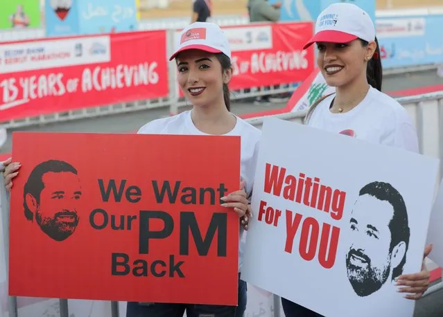 Supporters of Lebanon's resigned prime minister Saad Hariri hold up placards demanding his return from Saudi Arabia on the starting line of Beirut's annual marathon on November 12, 2017. Hariri announced on November 4 in a televised statement from Riyadh that he would be stepping down from the post, sending shock waves through Lebanese politics. The premier has yet to return to Lebanon and rumours have swirled that he is being held in Saudi Arabia against his will. (Photo by Anwar Amro/AFP Photo)