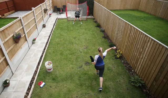 British Baseball players Kelly and Kirstie Wright during a training session at home, following the outbreak of the coronavirus disease (COVID-19), Prescot, Britain, June 22, 2020. (Photo by Carl Recine/Reuters)