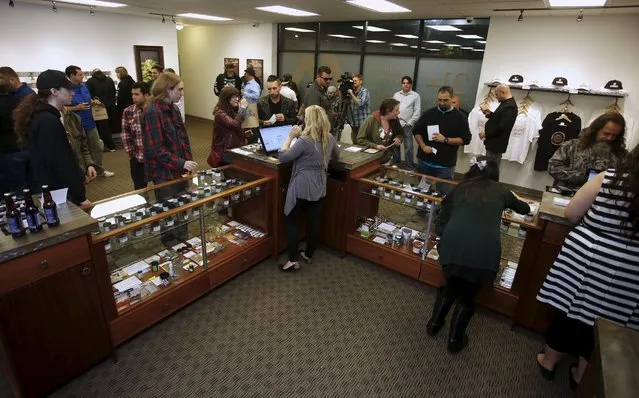 Customers are seen inside Shango Cannabis shop to purchase legal recreational marijuana beginning at midnight in Portland, Oregon October 1, 2015. (Photo by Steve Dipaola/Reuters)