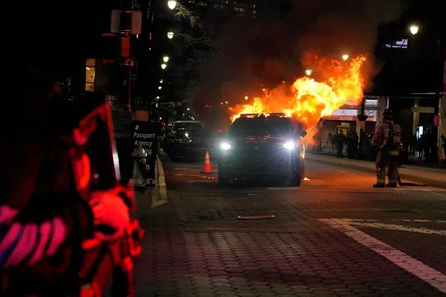 A law enforcement vehicle is seen lit on fire during demonstrations related to the death of Manuel Teran who was killed during a police raid inside Weelaunee People's Park, the planned site of a controversial “Cop City” project, in Atlanta, Georgia, U.S., January 21, 2023. (Photo by Cheney Orr/Reuters)