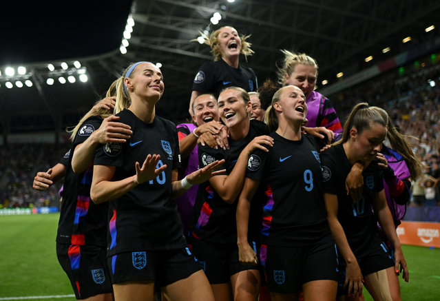 Chloe Kelly of England celebrates with her teammates after scoring her team's second goal from a rebound following a saved penalty in extra-time during the UEFA Women's EURO 2025 Semi-Final match between England and Italy at Stade de Geneve on July 22, 2025 in Geneva, Switzerland. (Photo by Harriet Lander – The FA/The FA via Getty Images)