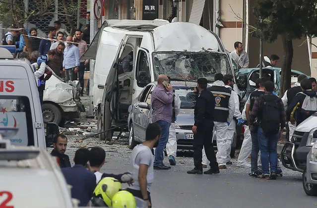 Police officers work at the scene of a blast in Istanbul, Thursday, October 6, 2016. A bomb placed on a motorcycle has exploded near a police station Thursday, wounding several people, Vasip Sahin, the governor for Istanbul, said. (Photo by Emrah Gurel/AP Photo)