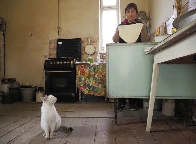 Baker Alla Mayrik prepares to bake bread for the soldiers on the frontline in Askeran, the separatist region of Nagorno-Karabakh, Thursday, October 22, 2020. Heavy fighting over Nagorno-Karabakh continued Thursday with Armenia and Azerbaijan trading blame for new attacks, hostilities that raised the threat of Turkey and Russia being drawn into the conflict. (Photo by AP Photo/Stringer)