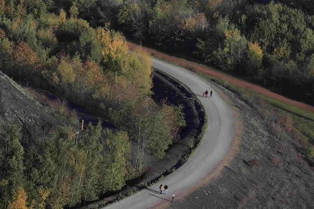 Hikers are seen on the path of the 11/19 pit and twin slag heaps at the former coal mine site in Loos-en-Gohelle, northern France, October 31, 2015. (Photo by Pascal Rossignol/Reuters)