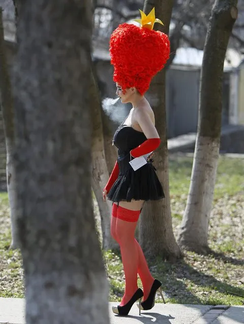 A model takes a smoke break at the 7th international festival of hairdressing art, fashion and design called “Crystal Angel” in Kiev, Ukraine, on April 18, 2013. (Photo by Gleb Garanich/Reuters)