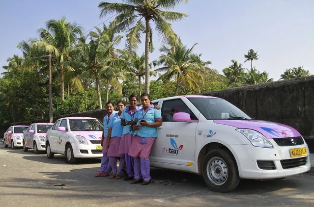 Female drivers from the “She Taxi” service pose next to a taxi on a road in the southern Indian city of Kochi, December 12, 2014. The alleged rape of a woman passenger by an Uber taxi driver once again spotlights the risks of India's transport system, which fails to keep women safe. (Photo by Sivaram V./Reuters)