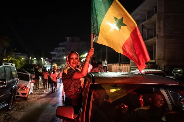 Supporters celebrate in Dakar on January 06, 2022, after Senegal won the Africa Cup of Nation (CAN) final against Egypt in Yaounde, Cameroon. (Photo by John WesselsAFP Photo)