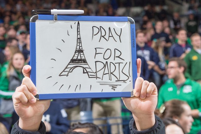 A student holds a sign in recognition of the attacks in Paris before the game between the Notre Dame Fighting Irish and the St. Francis Red Flash at the Purcell Pavilion, November 13, 2015. (Photo by Matt Cashore/USA TODAY Sports)