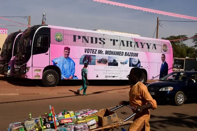 An electoral poster for the Nigerien Party for Democracy and Socialism candidate Mohamed Bazoum is seen in Niamey on December 6, 2020 plastered on the side of a bus. (Photo by Boureima Hama/AFP Photo)