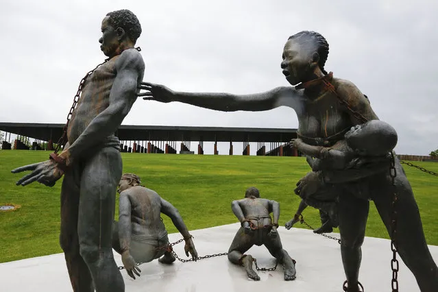 Part of a statue depicting chained people is on display at the National Memorial for Peace and Justice, a new memorial to honor thousands of people killed in racist lynchings, Sunday, April 22, 2018, in Montgomery, Ala. The national memorial aims to teach about America's past in hope of promoting understanding and healing. It's scheduled to open on Thursday. (Photo by Brynn Anderson/AP Photo)