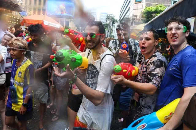People play with water as they celebrate the Songkran holiday which marks the Thai New Year in Bangkok, Thailand on April 13, 2023. (Photo by Athit Perawongmetha/Reuters)