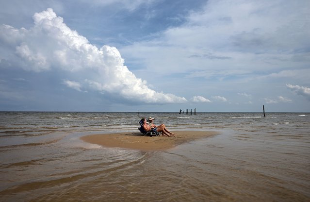 Mississippi residents Lawrence and Gillian relax on a sandbar on Waveland Beach, a town which was hard-hit by Hurricane Katrina, on August 04, 2025 in Waveland, Mississippi. The catastrophic storm sent an approximately 30-foot-high storm surge into Waveland and destroyed or damaged nearly every home in the town. New Orleans and the Gulf Coast region are preparing to mark the 20-year anniversary of Hurricane Katrina, which occurred on August 29, 2005. Katrina resulted in nearly 1,400 deaths, according to revised statistics from the National Hurricane Center, and remains the costliest storm in U.S. history at around $200 billion in todayÕs dollars. (Photo by Mario Tama/Getty Images)