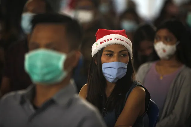 Indonesian Catholics wearing face masks to protect against coronavirus, attend a Christmas mass service at a church in Bali, Indonesia on Thursday, December 24, 2020. (Photo by Firdia Lisnawati/AP Photo)