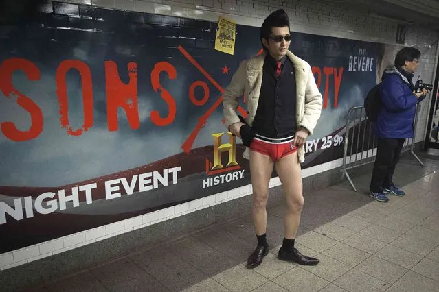 A participant taking part in the “No Pants Subway Ride” stands near an advertisement in the Manhattan borough of New York January 11, 2015. (Photo by Carlo Allegri/Reuters)