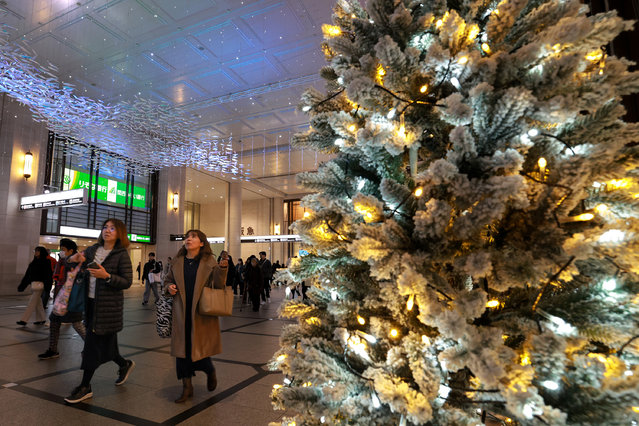 Shoppers walk past the holiday decorations during the Christmas shopping season on December 18, 2025 in Osaka, Japan. (Photo by Buddhika Weerasinghe/Getty Images)