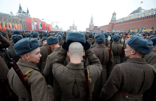 Servicemen dressed in historical uniforms wait before a military parade marking the anniversary of the 1941 parade when Soviet soldiers marched towards the front lines of World War Two, in Red Square in Moscow, Russia, November 7, 2016. (Photo by Maxim Shemetov/Reuters)