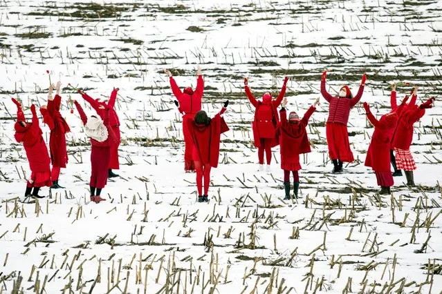 Women in red clothing dance holding up red tulips as they welcome the meteorological spring during a protest against the Belarus presidential election results near the village of Maloje Zapruddzie, some 95 kilometers northwest of Minsk on March 1, 2021. (Photo by AFP Photo/Stringer)
