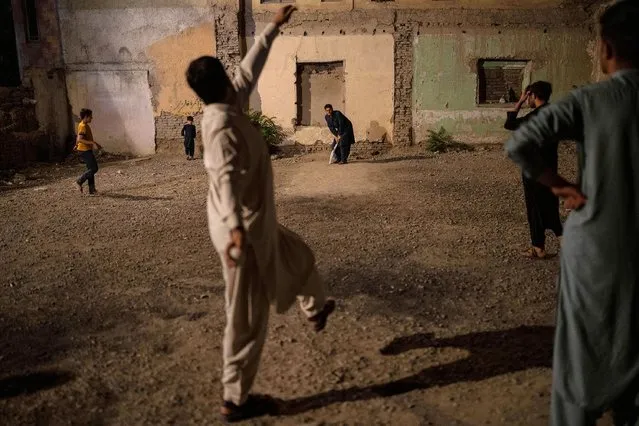 Men play cricket at night due to high temperatures during the day in Kabul, Afghanistan, Thursday, June 22, 2023. (Photo by Rodrigo Abd/AP Photo)
