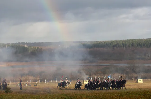 People dressed in the historic uniforms of the French army take part in a re-enactment of the 1812 Battle of Berezina, to mark the 204th anniversary of the battle, near the village of Bryli, Belarus, November 27, 2016. (Photo by Vasily Fedosenko/Reuters)