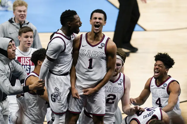 Gonzaga guard Jalen Suggs (1) celebrates making the game winning basket with Joel Ayayi, left, against UCLA during overtime in a men's Final Four NCAA college basketball tournament semifinal game, Saturday, April 3, 2021, at Lucas Oil Stadium in Indianapolis. Gonzaga won 93-90. (Photo by Michael Conroy/AP Photo)