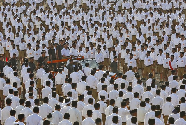 Mohan Bhagwat (standing front L on vehicle), chief of the Hindu nationalist organisation Rashtriya Swayamsevak Sangh (RSS), inspects volunteers during a conclave on the outskirts of Pune, India, January 3, 2016. (Photo by Danish Siddiqui/Reuters)