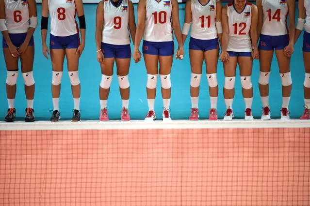 Philippines' players hold hands before their women's Group A preliminary volleyball match against Thailand at the 2018 Asian Games in Jakarta on August 19, 2018. (Photo by Anthony Wallace/AFP Photo)
