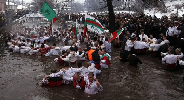 Bulgarian men dance in the icy waters of the Tundzha river during a celebration for Epiphany Day in the town of Kalofer, Bulgaria January 6, 2016. (Photo by Stoyan Nenov/Reuters)