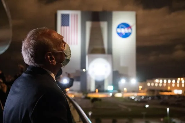 This handout image courtesy of NASA, shows acting NASA Administrator Steve Jurczyk watching the launch of a SpaceX Falcon 9 rocket carrying the company's Crew Dragon spacecraft on NASA’s Crew-2 mission at the Kennedy Space Center in Florida on April 23, 2021. SpaceX launched its third crew to the International Space Station an hour before sunrise Friday, recycling a rocket and spacecraft for the first time. The Crew-2 mission, the first involving a European, blasted off from the Kennedy Space Center in Florida at 5:49 am Eastern Time (0949 GMT). (Photo by Aubrey Gemignani/NASA)