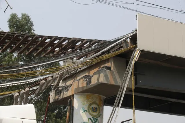 A view shows a part of the damage caused by an accident where an overpass for a metro partially collapsed with train cars on it, in Mexico City, Mexico on May 5, 2021. (Photo by Henry Romero/Reuters)