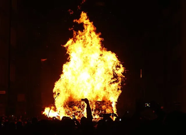 Burning wooden sticks are seen during the traditional Swiss Chienbaese celebration in Liestal near Basel February 22, 2015. (Photo by Ruben Sprich/Reuters)