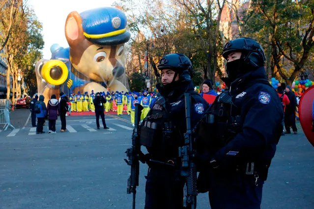 Members of the New York Police Department take a position along the route before the start of the 92nd annual Macy's Thanksgiving Day Parade in New York, Thursday, November 22, 2018. (Photo by Eduardo Munoz Alvarez/AP Photo)