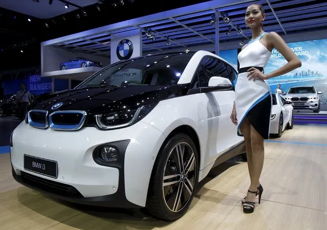 A model poses beside a BMW i3 during a media presentation of the 36th Bangkok International Motor Show in Bangkok March 24, 2015. (Photo by Chaiwat Subprasom/Reuters)
