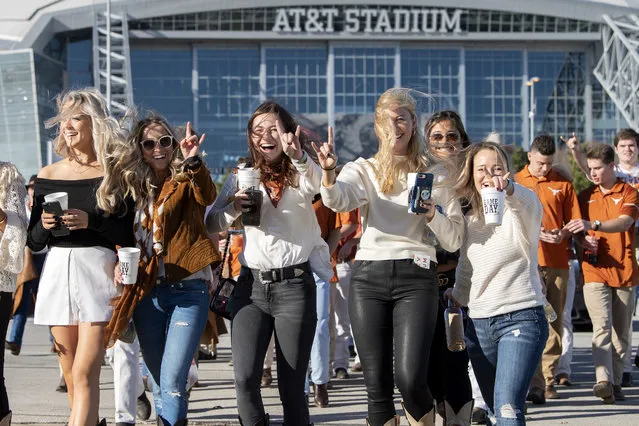 Texas fans head to a tailgate party before the Big 12 Conference championship NCAA college football game against Oklahoma on Saturday, December 1, 2018, in Arlington, Texas. (Photo by Jeffrey McWhorter/AP Photo)