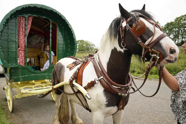 Travellers make their way to Appleby, England, for the annual Horse Fair, Wednesday August 11, 2021. The Appleby Horse Fair is a traditional annual event, and in the past has attracted up to 10,000 people of mostly nomadic Romani people and Travellers to the town of Appleby. (Photo by Owen Humphreys/PA Wire via AP Photo)