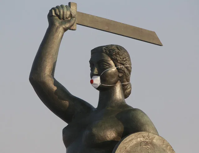 A statue of a mermaid, the symbol of Warsaw, wears a mask during smog alert in Warsaw, Poland, on Monday January 9, 2017. Local activists put the mask on the statue to raise awareness about the dangerous levels of air pollution in Poland. (Photo by Czarek Sokolowski/AP Photo)