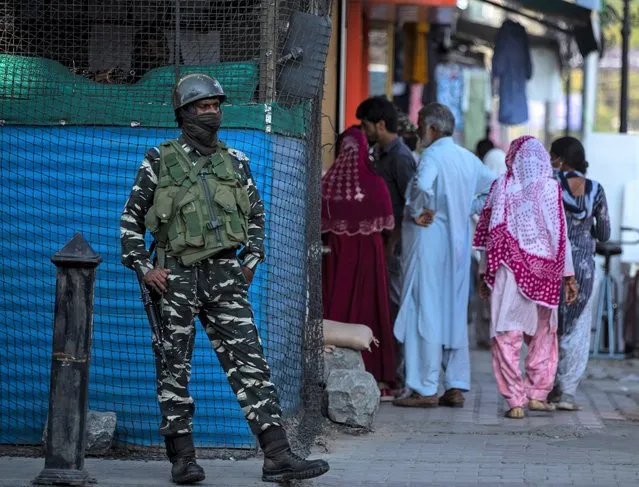 An Indian paramilitary soldier guard outside his post in Srinagar, Indian controlled Kashmir, Tuesday, August 24, 2021. (Photo by Mukhtar Khan/AP Photo)