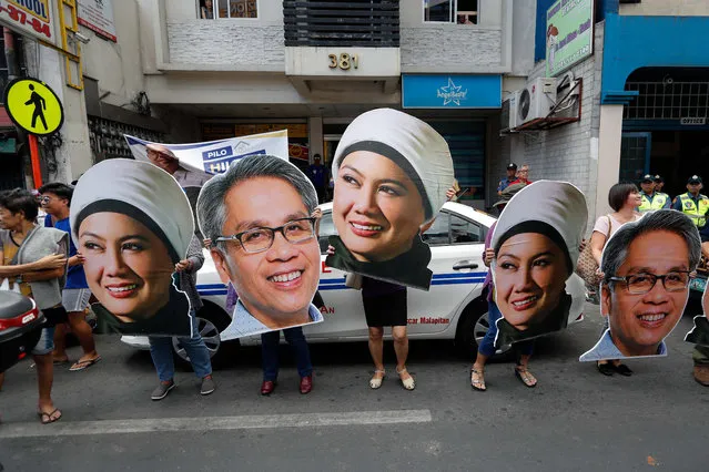 Cardboard cutouts of senatorial candidates are paraded along a road during a campaign in Caloocan City, north of Manila, Philippines, 12 February 2019. The 90 day campaign period for national candidates has officially begun with over 60 senatorial candidates and 150 party-list groups running. (Photo by Mark R. Cristino/EPA/EFE)