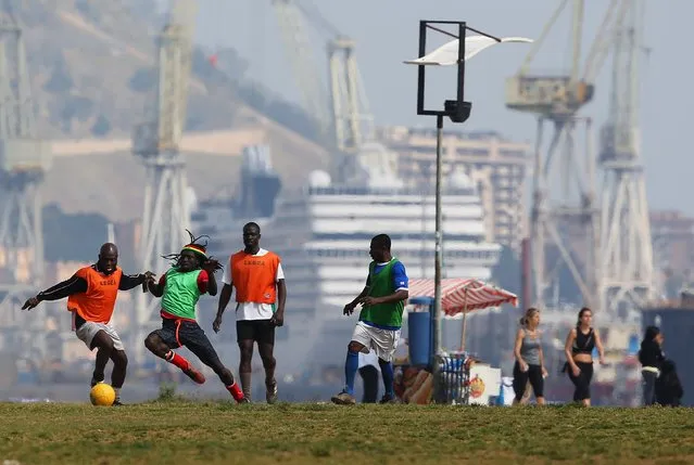 Migrants play soccer in front of the Sicilian harbour of Palermo April 19, 2015. (Photo by Alessandro Bianchi/Reuters)