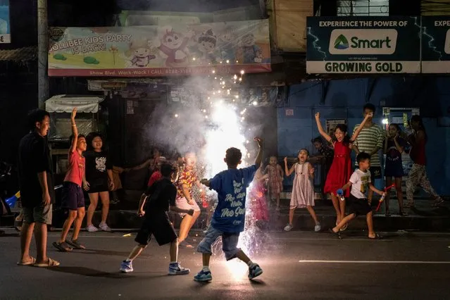 Children play during New Year's Eve celebrations at a street in Mandaluyong, Metro Manila, Philippines on December 31, 2023. (Photo by Eloisa Lopez/Reuters)