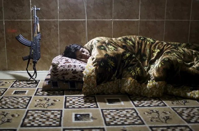 A female Kurdistan Workers Party (PKK) fighter sleeps at a base in Sinjar, March 11, 2015. (Photo by Asmaa Waguih /Reuters)