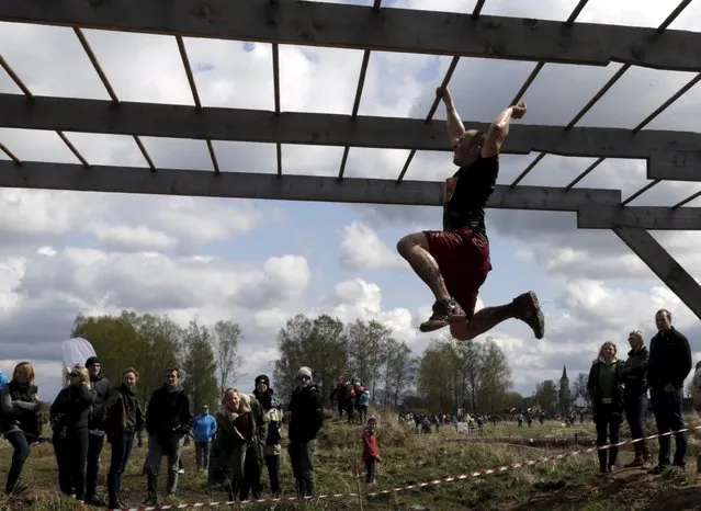 Participant competes during the Strong Race event near Tukums, Latvia May 3, 2015. (Photo by Ints Kalnins/Reuters)