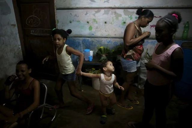 Family members of Yolanda Sanchez, (not pictured), chat in their home in Havana, March 19, 2016. (Photo by Alexandre Meneghini/Reuters)